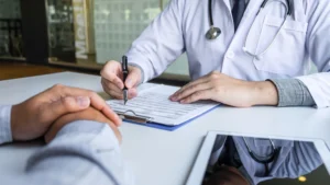 A doctor works through an intake form with an outpatient detox client.
